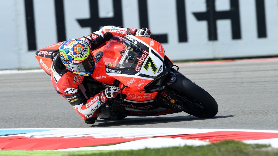 ducati rider racing on track leaning into a corner
